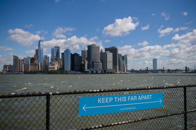 <p>A sign to promote social distancing is seen on Governors Island, New York</p>