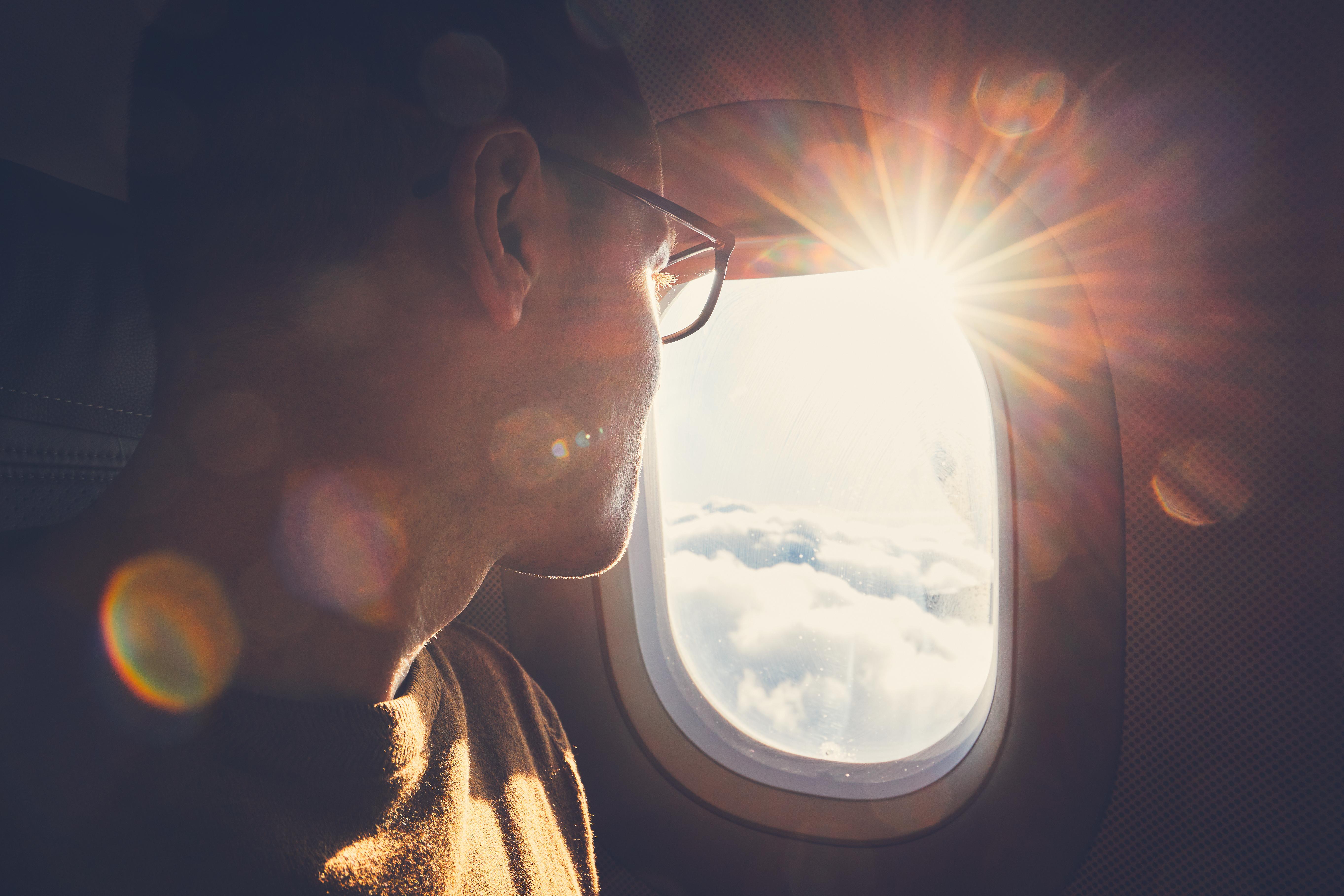 Man looking out plane window