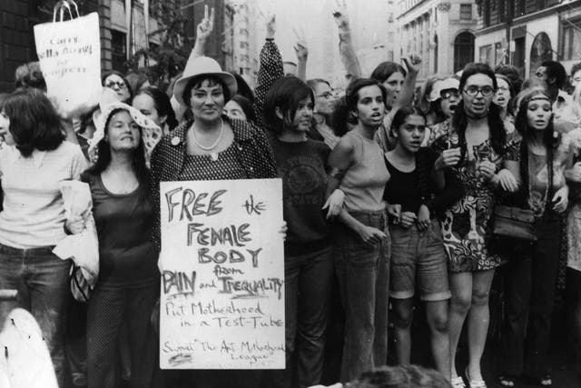 <p>Bella Abzug carries an anti-motherhood sign on the 50th anniversary of women winning the vote in the United States</p>