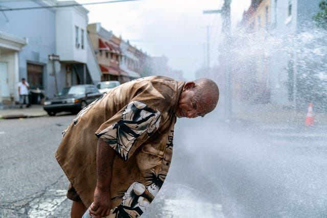 Eduardo Velev cools off in the spray of a fire hydrant during a heatwave on July 1, 2018 in Philadelphia, Pennsylvania. America is hotter than ever, latest NOAA data reveals