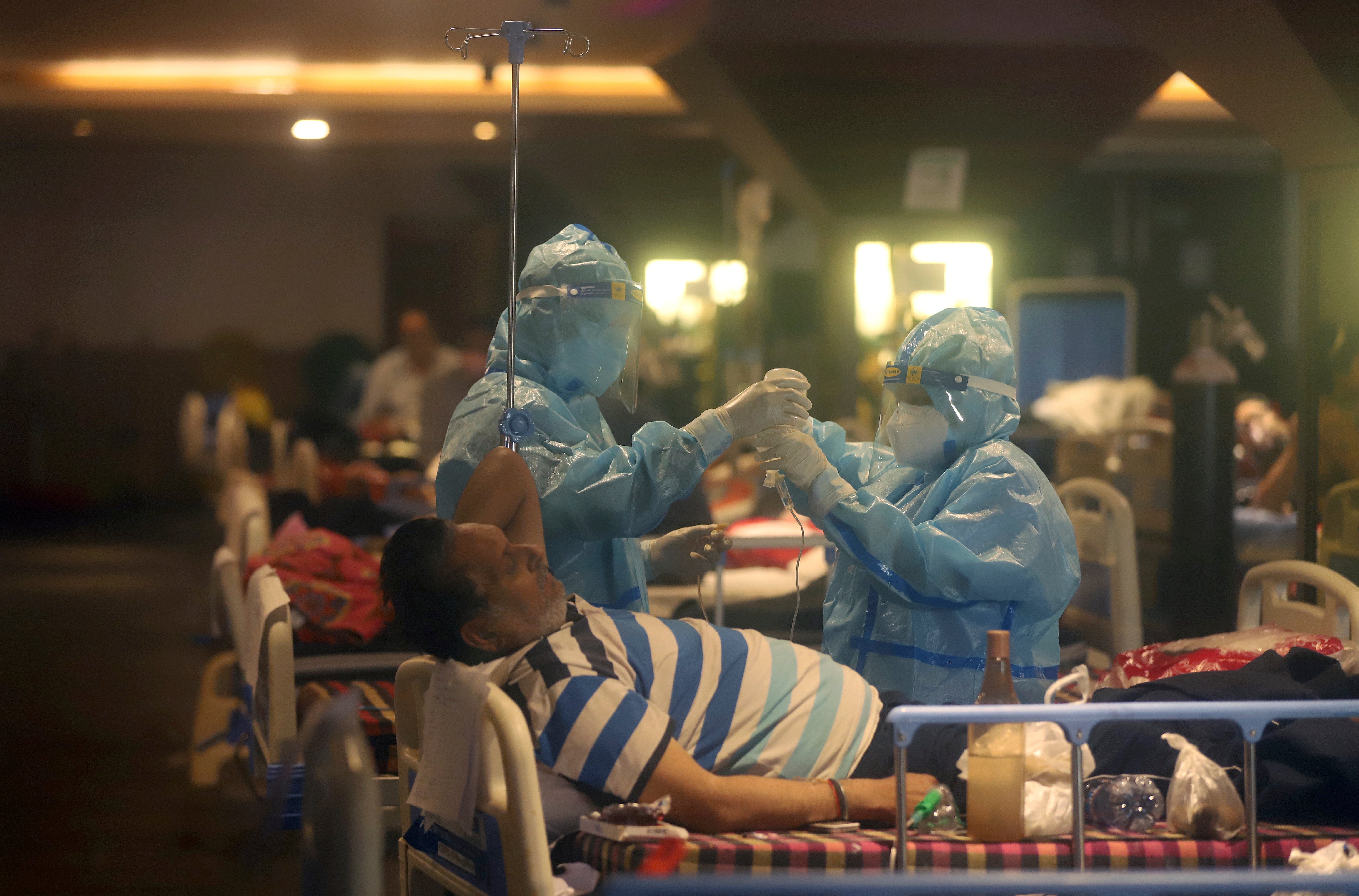 Health workers attend to Covid-19 patients at a makeshift Delhi hospital