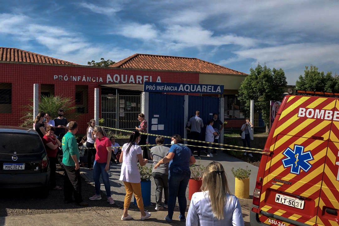 Photo released by Brazilian newspaper Imprensa do Povo showing people and local authorities at the surroundings of the Aquarela Daycare School