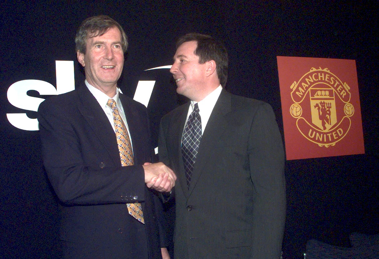 Martin Edwards (left), director of Manchester United, shakes hands with Mark Booth, chief executive of BSkyB, at a news conference at Old Trafford in September 1998, following the announcement that Rupert Murdoch had bought the football club