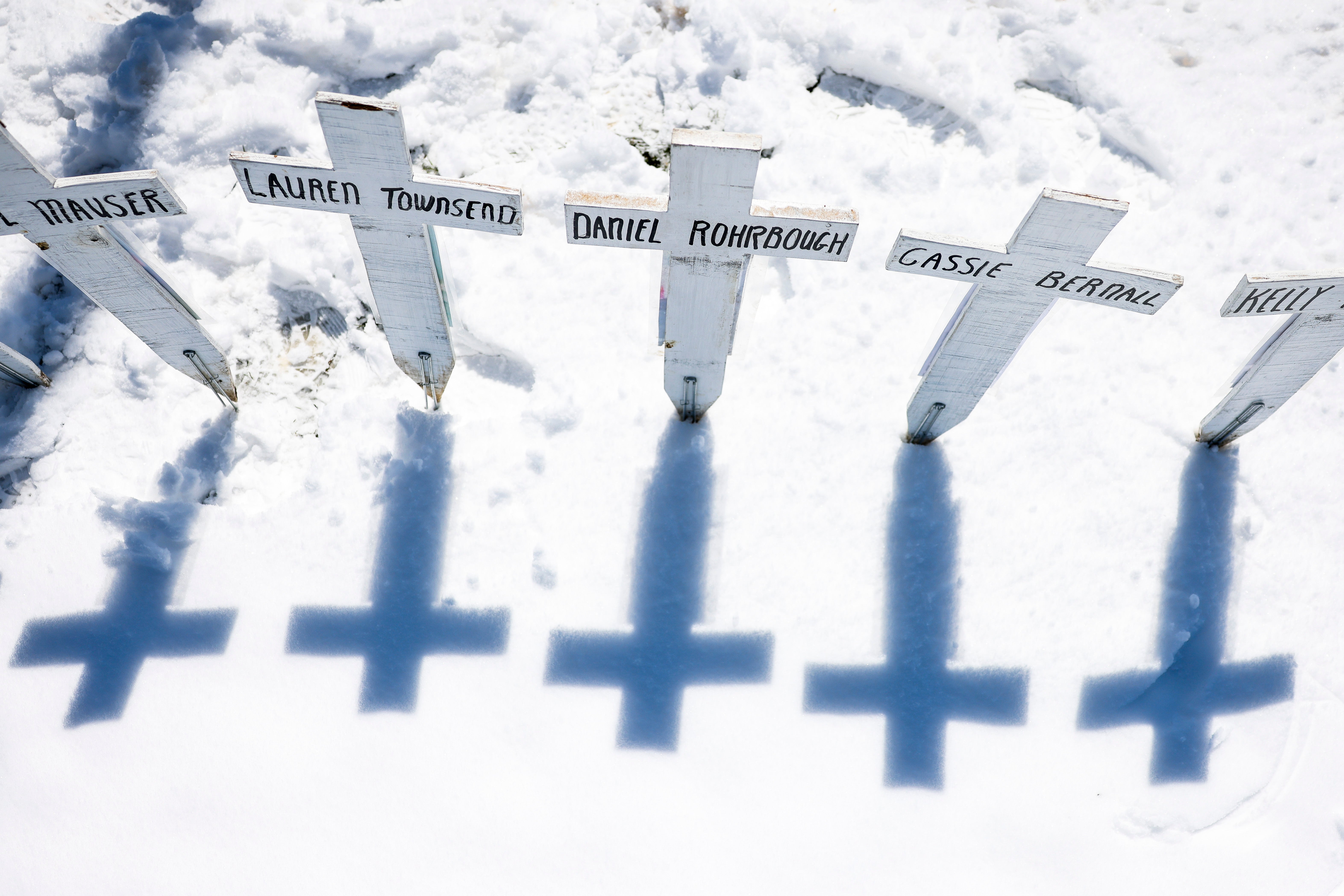 Crosses with the names of the victims of the Columbine High School shooting sit next to the Columbine Memorial in Littleton, Colorado