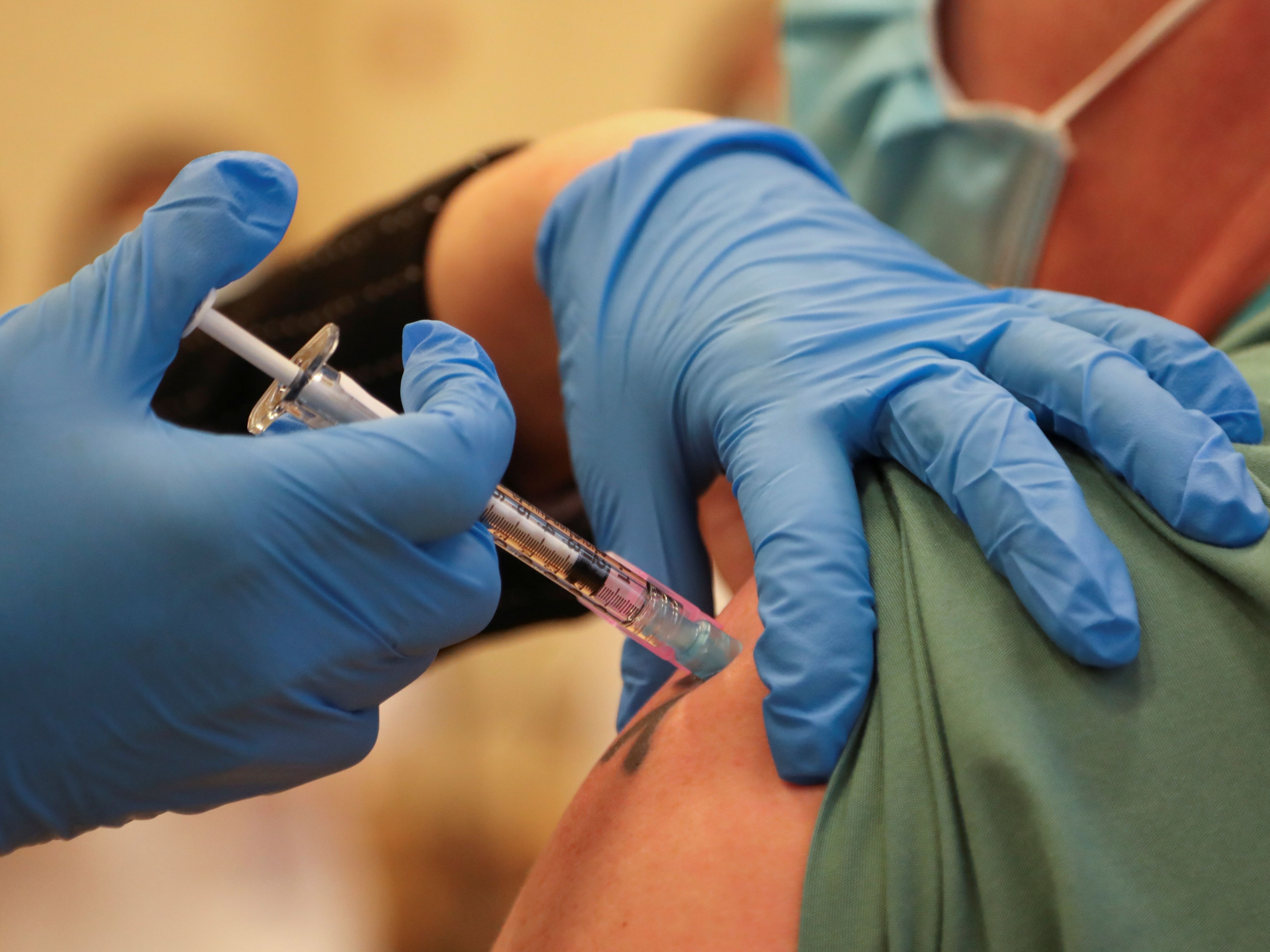 A man is injected with Pfizer’s vaccine at the Michener Institute in Toronto