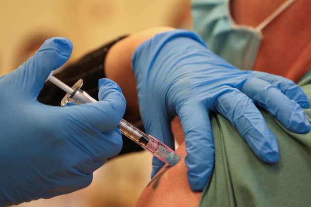 A man is injected with Pfizer’s vaccine at the Michener Institute in Toronto