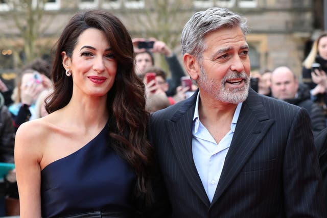 <p>George and Amal Clooney, representing the Clooney Foundation for Justice, arrive at the People’s Postcode Lottery charity gala at the McEwan Hall in Edinburgh</p>