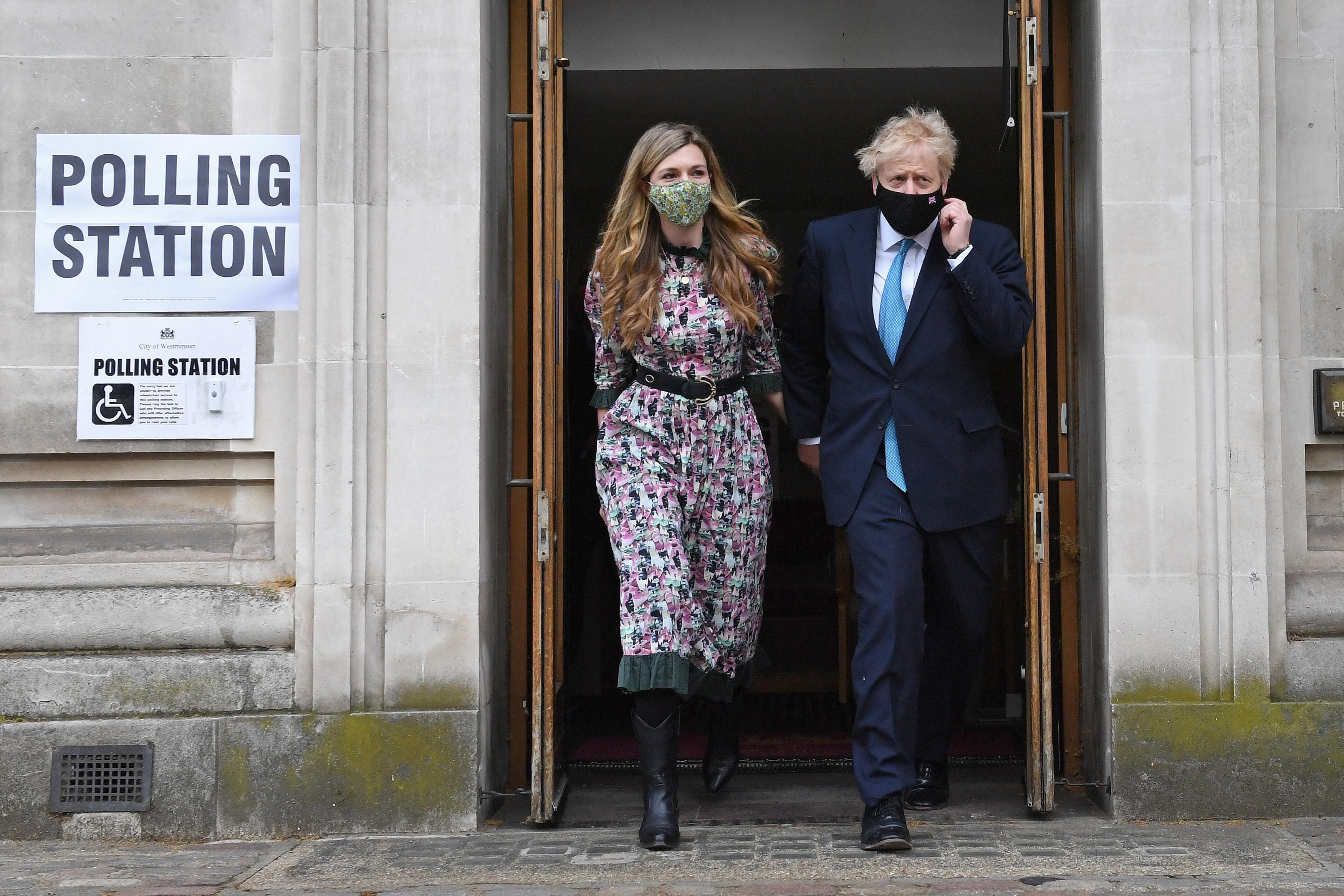 The PM and his fiancee Carrie Symonds leave after casting their vote at Methodist Central Hall, central London