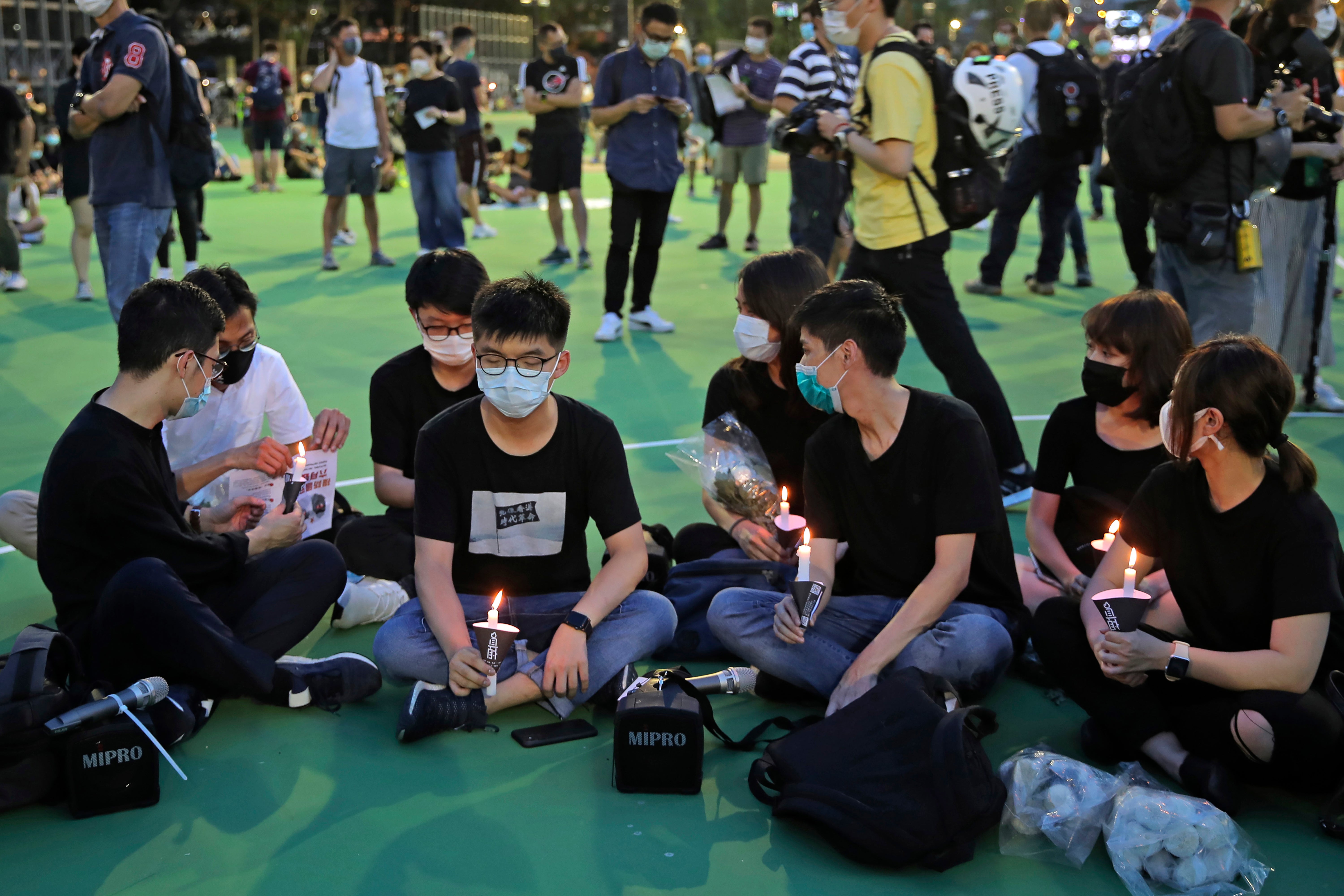 Hong Kong democracy activist Joshua Wong, second left, at the 4 June 2020 vigil for the victims of the 1989 Tiananmen Square Massacre