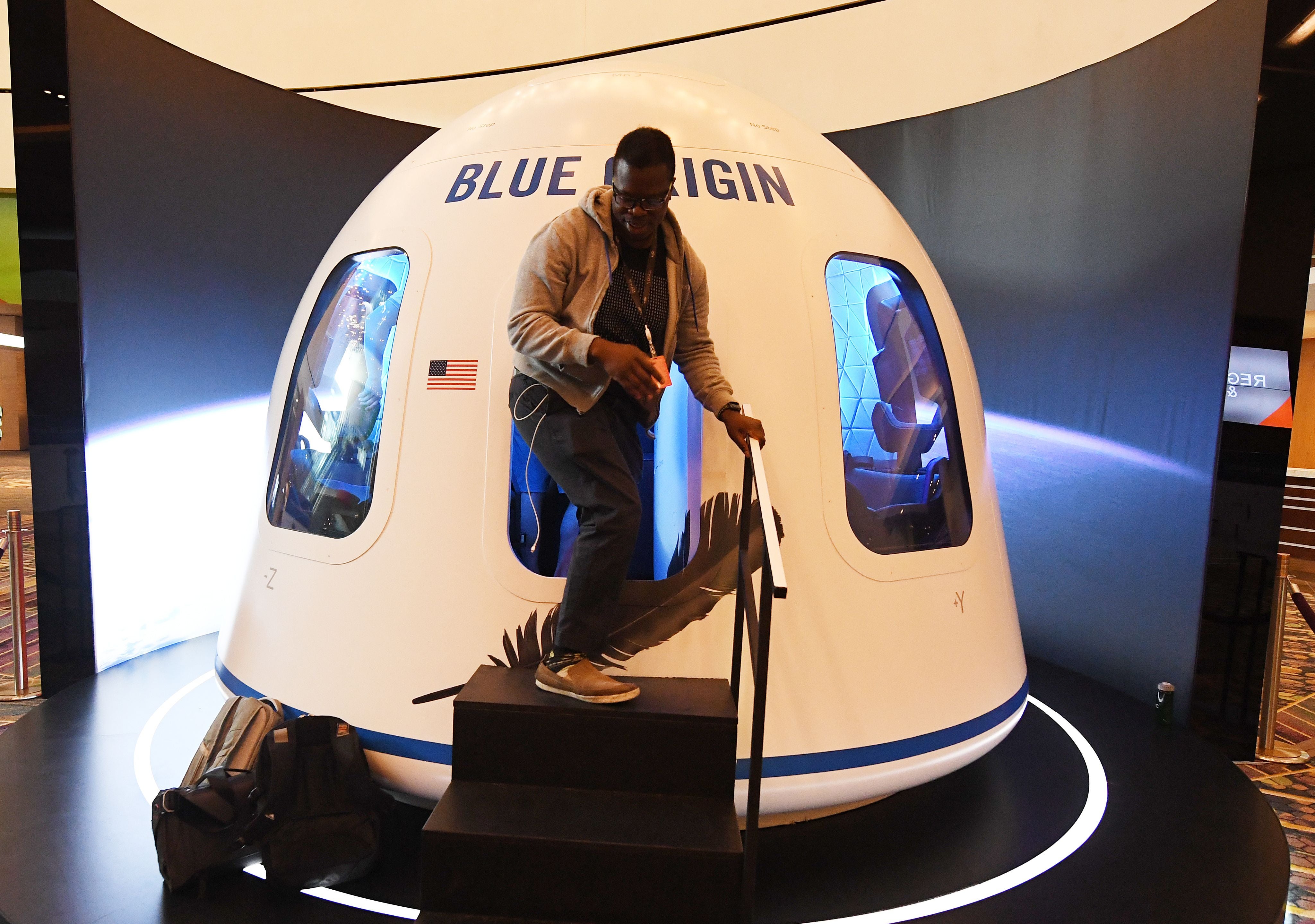 Participants leave the Blue Origin Space Simulator during the Amazon Re:MARS conference on robotics and artificial intelligence at the Aria Hotel in Las Vegas