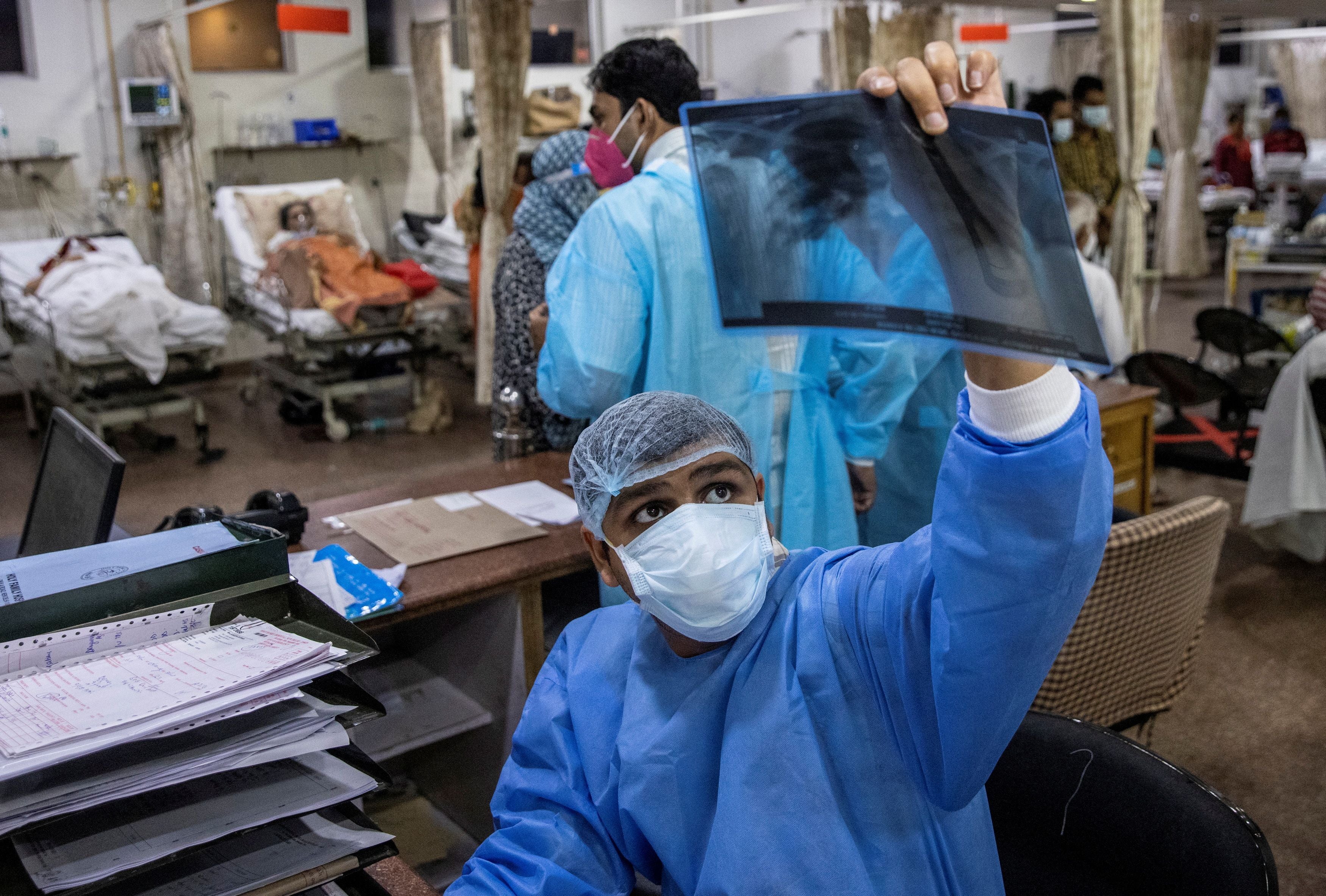 Rohan Aggarwal, 26, a resident doctor treating patients suffering from the coronavirus disease (COVID-19), looks at a patient’s x-ray scan during his 27-hour shift at Holy Family Hospital in New Delhi, India, May 1, 2021. “If a patient has a fever, and I know he’s sick but he’s not requiring oxygen, I can’t admit him,” said Aggarwal. “That’s the criteria. People are dying on the streets without oxygen. So people who don’t require oxygen, even if they are sick, we don’t admit them usually,” he added. “Another choice is I have an old male and I have a young guy. Both are requiring high-flow oxygen; I have only one bed in the ICU. And I can’t be emotional at that time, that he is a father to someone. The young have to be saved.” REUTERS/Danish Siddiqui