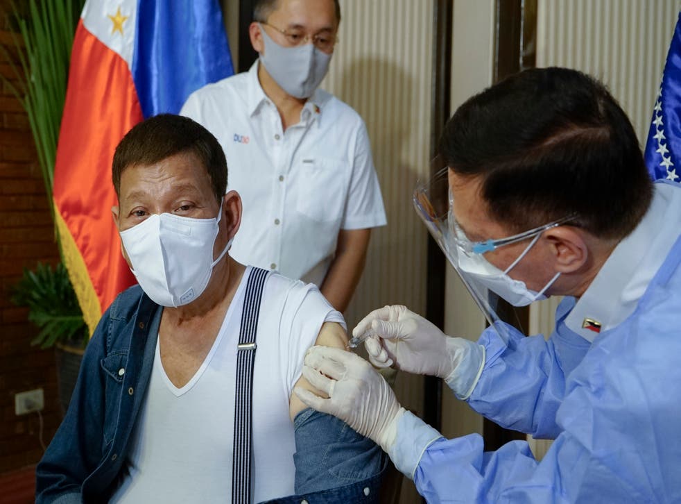 <p>In this photo provided by the Malacanang Presidential Photographers Division, Philippine President Rodrigo Duterte, left, is inoculated with China's Sinopharm Covid-19 vaccine by Health Secretary Fracisco Duque III at the Malacanang presidential palace in Manila, Philippines on3 May, 2021</p>