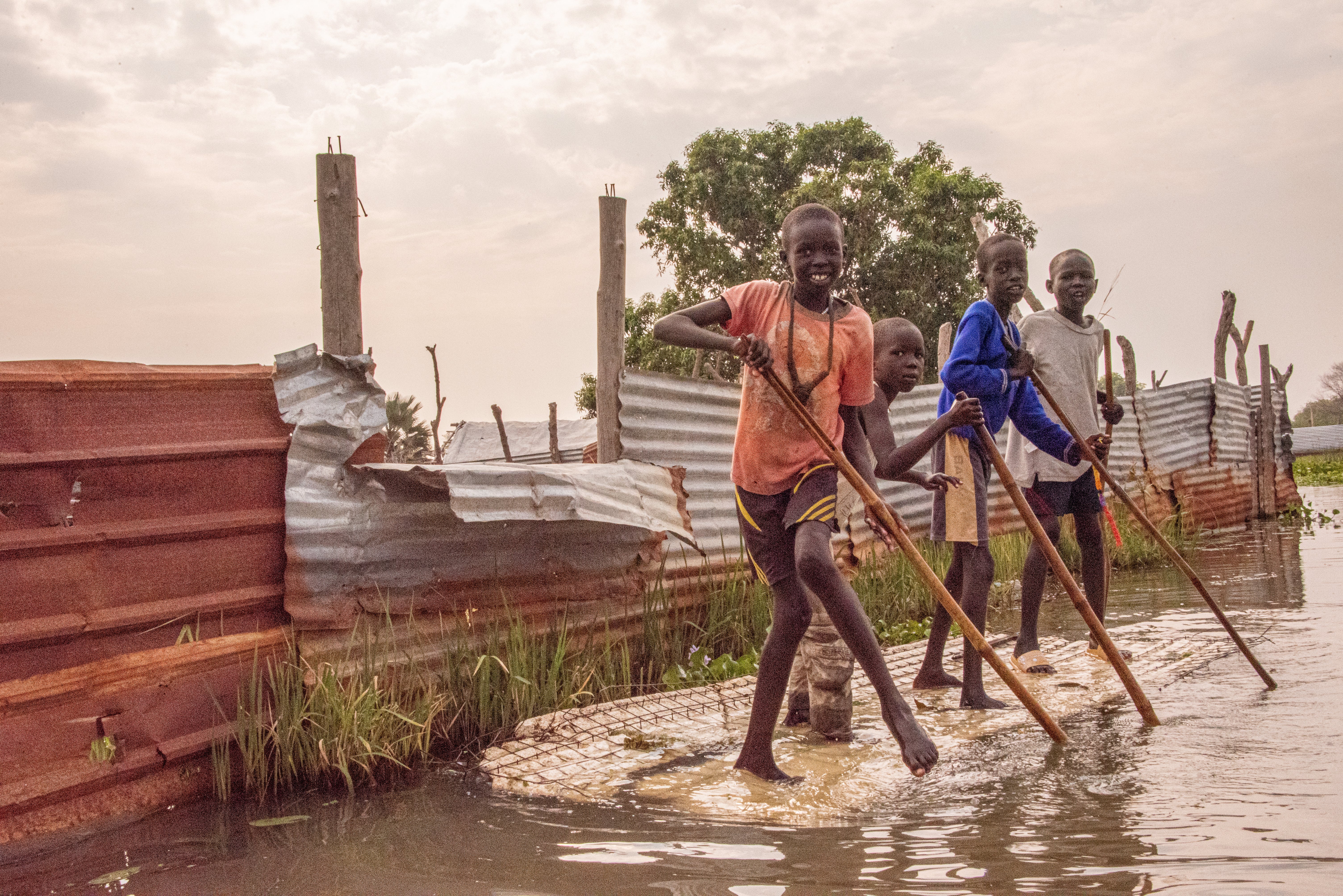 Children in Bor, where regular flooding means locals sometimes resort to canoes to get around