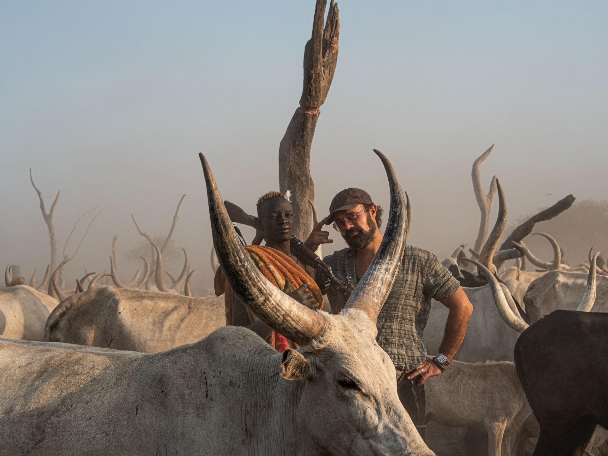 Independent shareholder Evgeny Lebedev meets a herder at a cattle camp in South Sudan