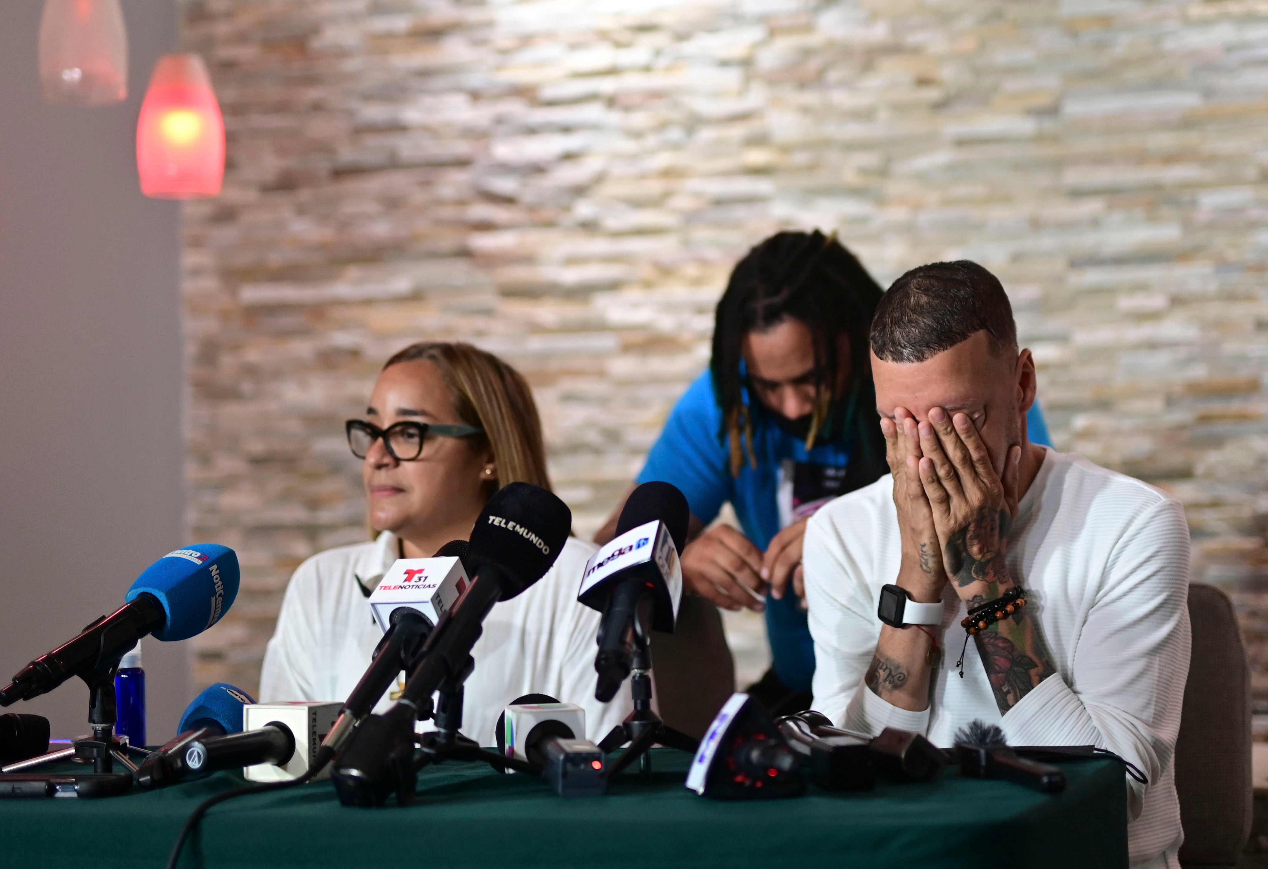 Mother Keila Ortiz, left, and father Jose Antonio Rodriguez, right, offer a press conference at the wake of their daughter Keishla Rodriguez