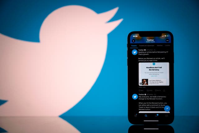 Logo of US social network Twitter displayed on the screen of a smartphone and a tablet