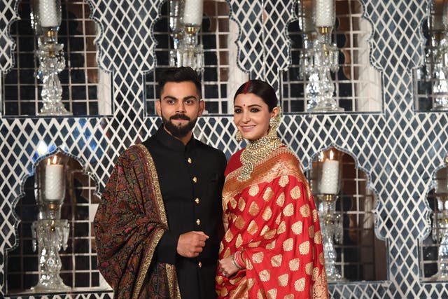 <p>Virat Kohli and Anushka Sharma at their wedding reception in New Delhi in 2017</p>