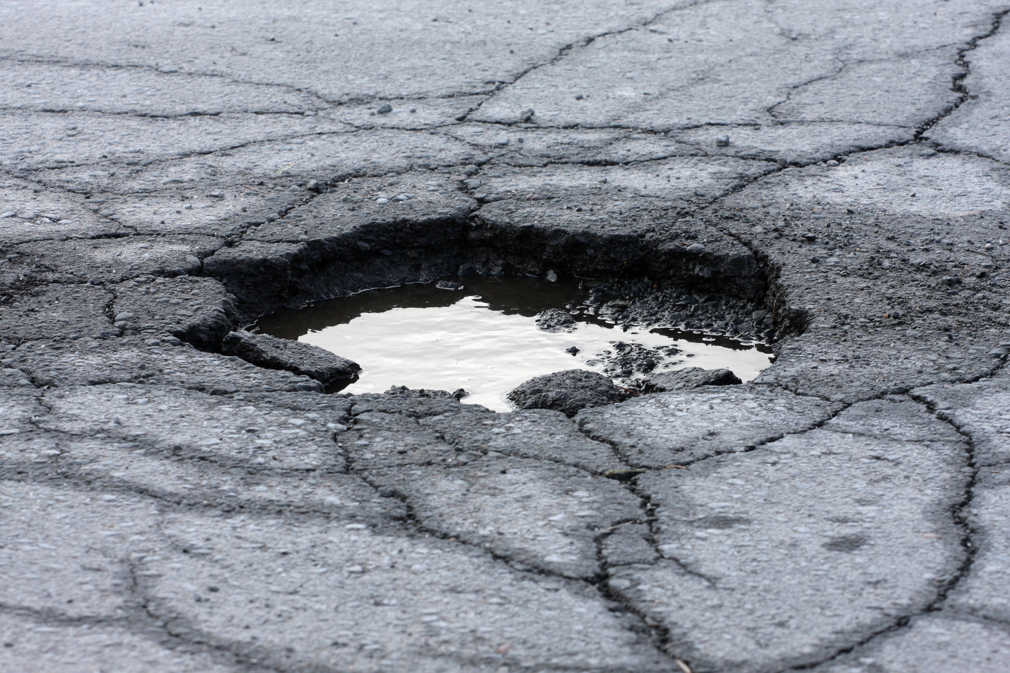 If you have comprehensive insurance, you can claim the damage that has been caused by the pothole