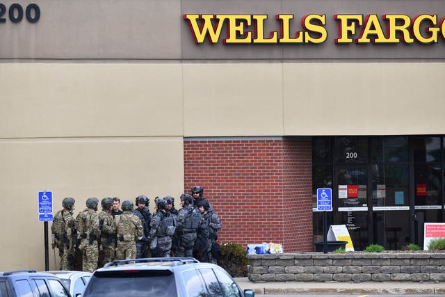 <p>Law enforcement officers gather near the entrance of a Wells Fargo Bank branch Thursday, 6 May 2021, in St Cloud, Minnesota</p>