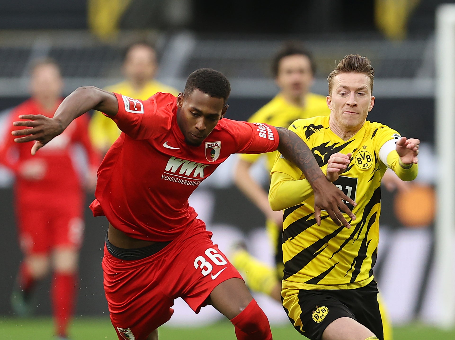 Reece Oxford vies for the ball against Borussia Dortmund’s Marco Reus
