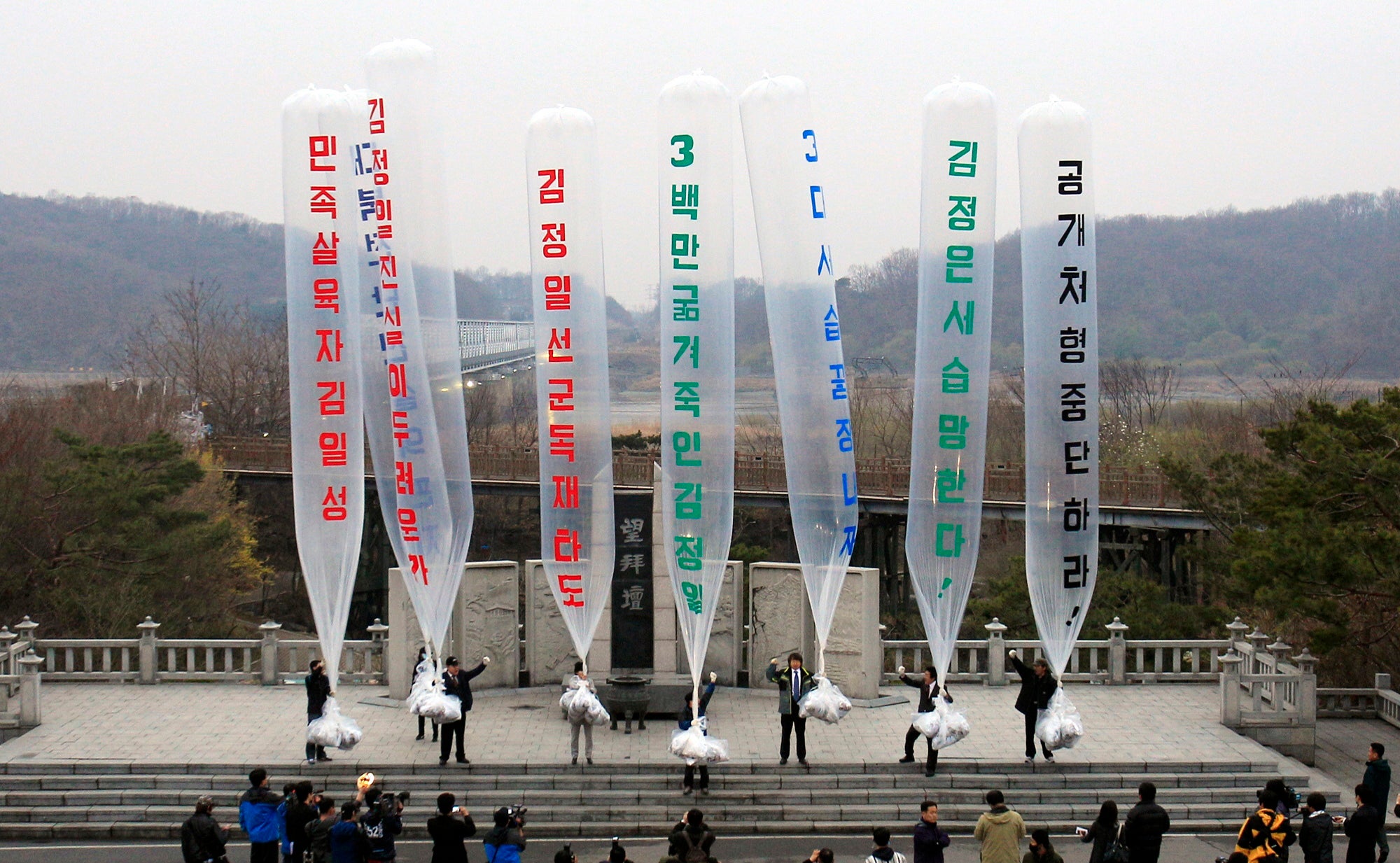 Park Sang-hak, center, a refugee from the North who now runs the group Fighters for a Free North Korea from a small Seoul office, and South Korean conservative activists prepare to release balloons bearing leaflets condemning North Korea in 2011