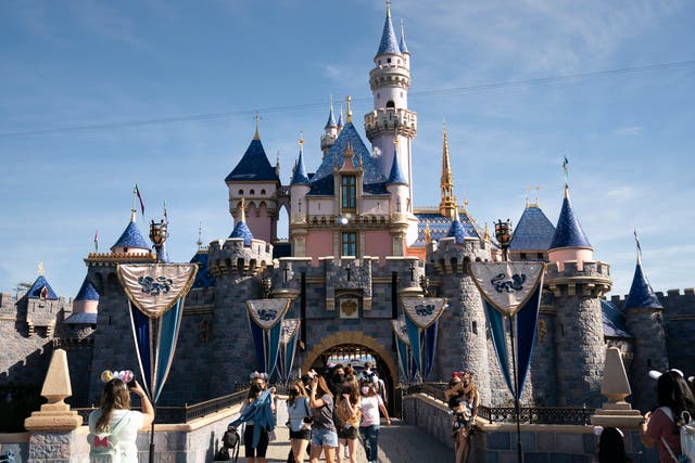 <p>Visitors exit The Sleeping Beauty Castle at Disneyland in Anaheim, California on 30 April 2021</p>