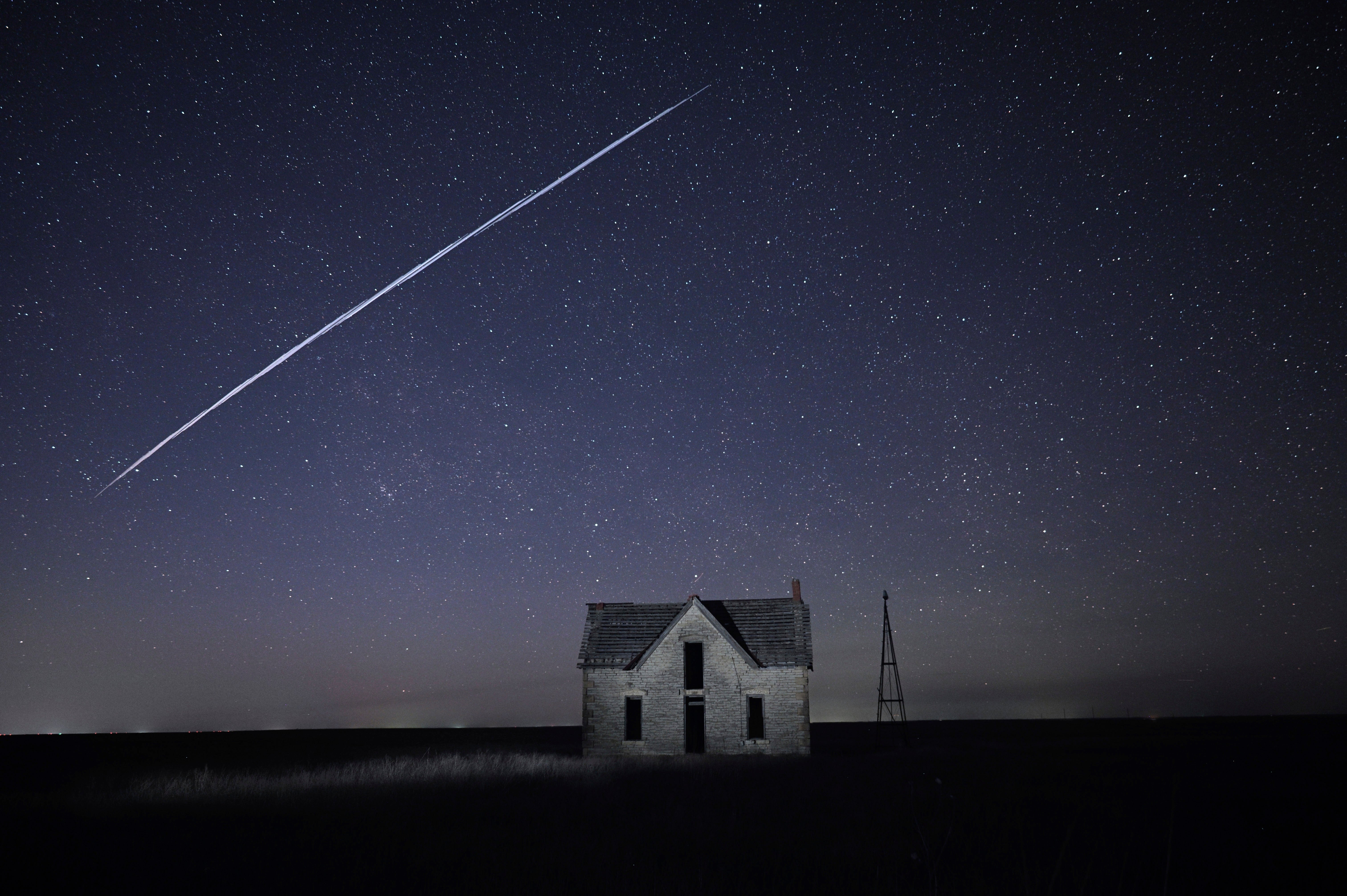 A string of SpaceX Starlink satellites passes over an old stone house near Florence, Kansas, 6 May, 2021