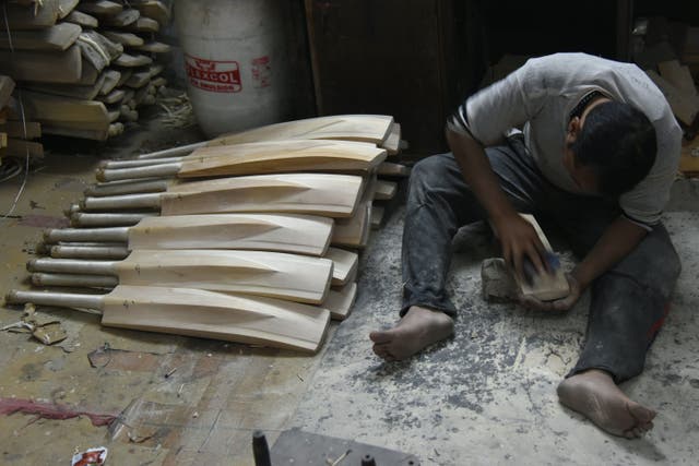 <p>An Indian craftsman works on unfinished cricket bats in a factory in Meerut</p>