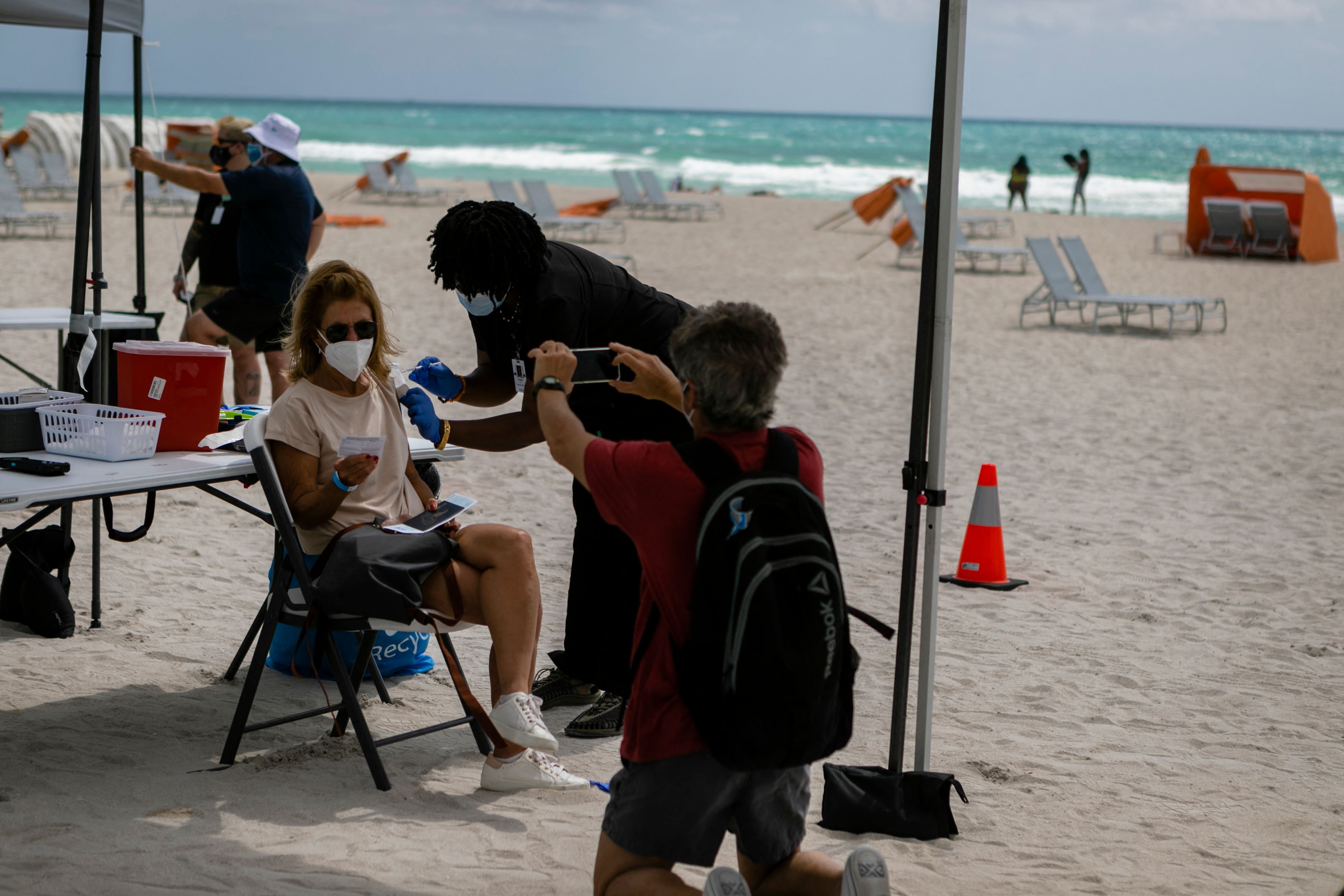 Representative: A woman gets a Johnson & Johnson Covid-19 vaccine at a pop-up vaccination center at the beach, in South Beach, Florida, on 9 May 2021.