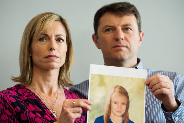 <p>Madeleine McCann’s parents Kate and Gerry holding an age-enhanced photo of their missing daughter </p>