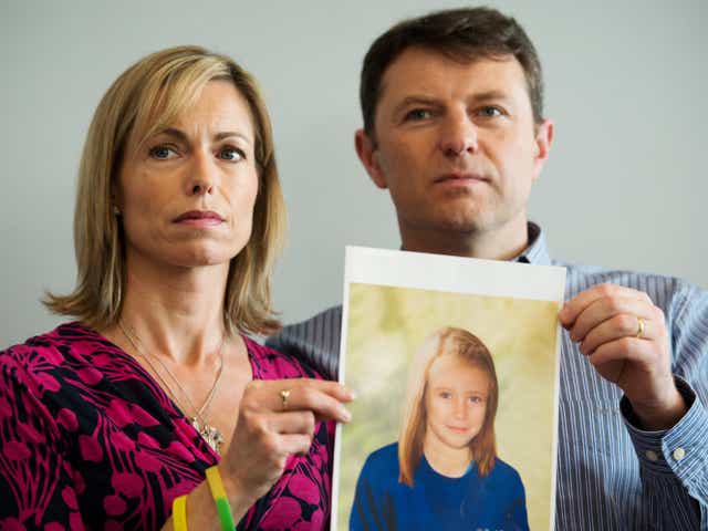 Kate and Gerry McCann hold up a computer-generated image of their missing daughter, Madeleine McCann, as she might look now