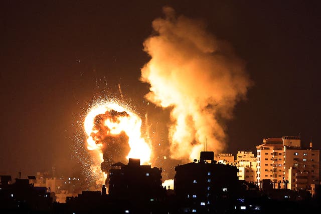 <p>Fire billows from Israeli air strikes in the Gaza Strip</p>