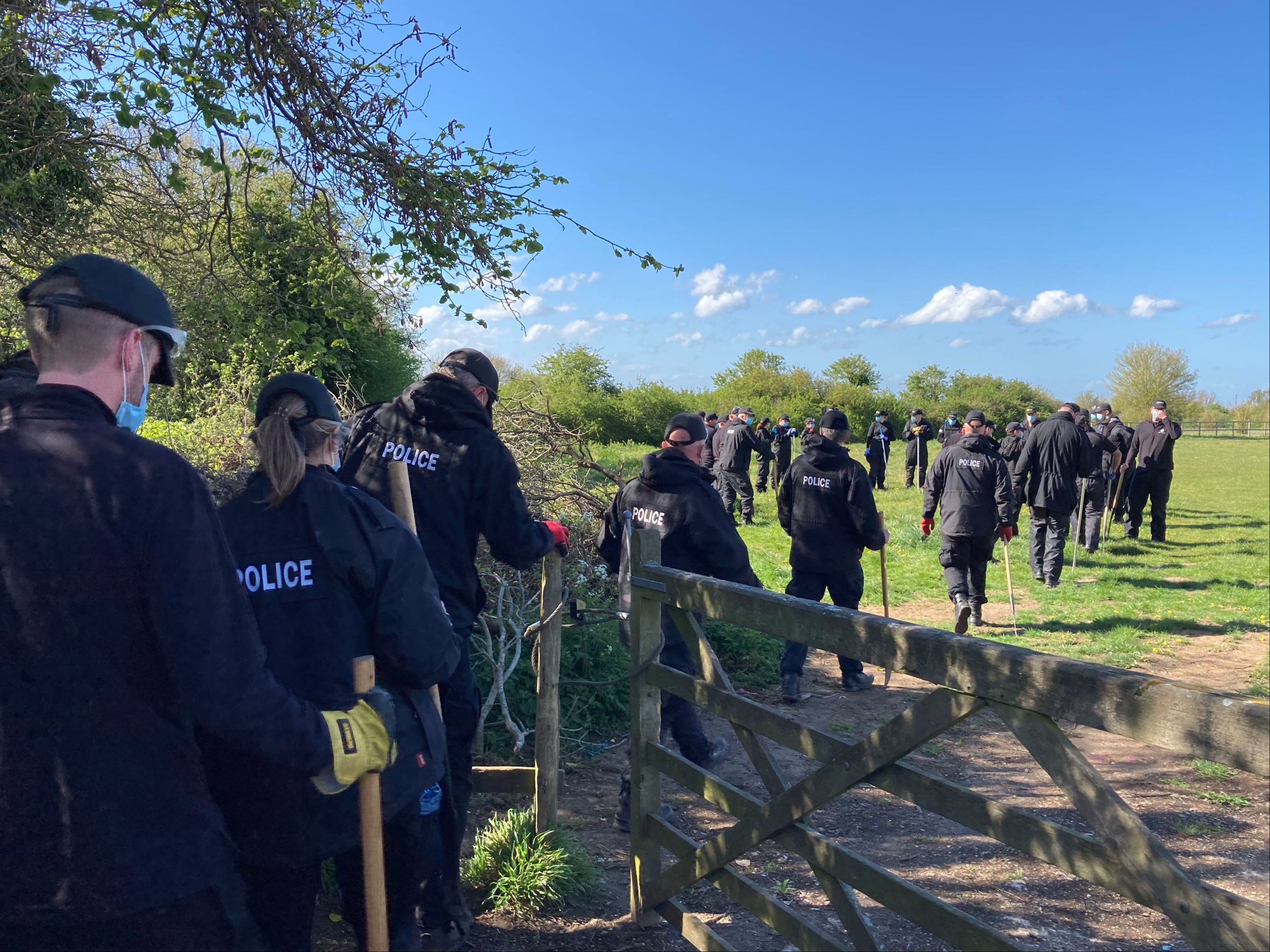 Police officers searching a field off Ratling Road in Aylesham, Kent, as the murder investigation into the death of PCSO Julia James continues