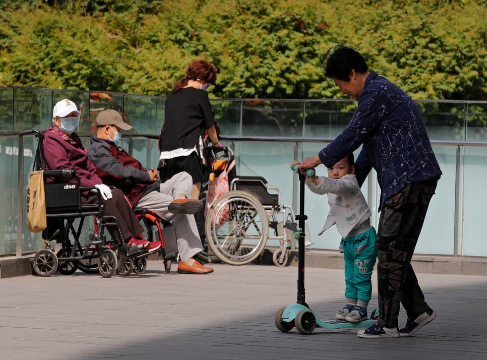 <p>File image: A woman plays with a child in Beijing on Monday, May 10, 2021</p>