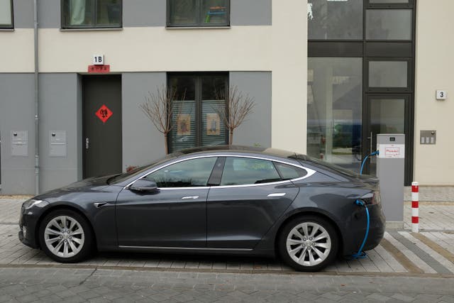 A Tesla Model S electric car charges at a public charging column on March 2, 2019 in Berlin