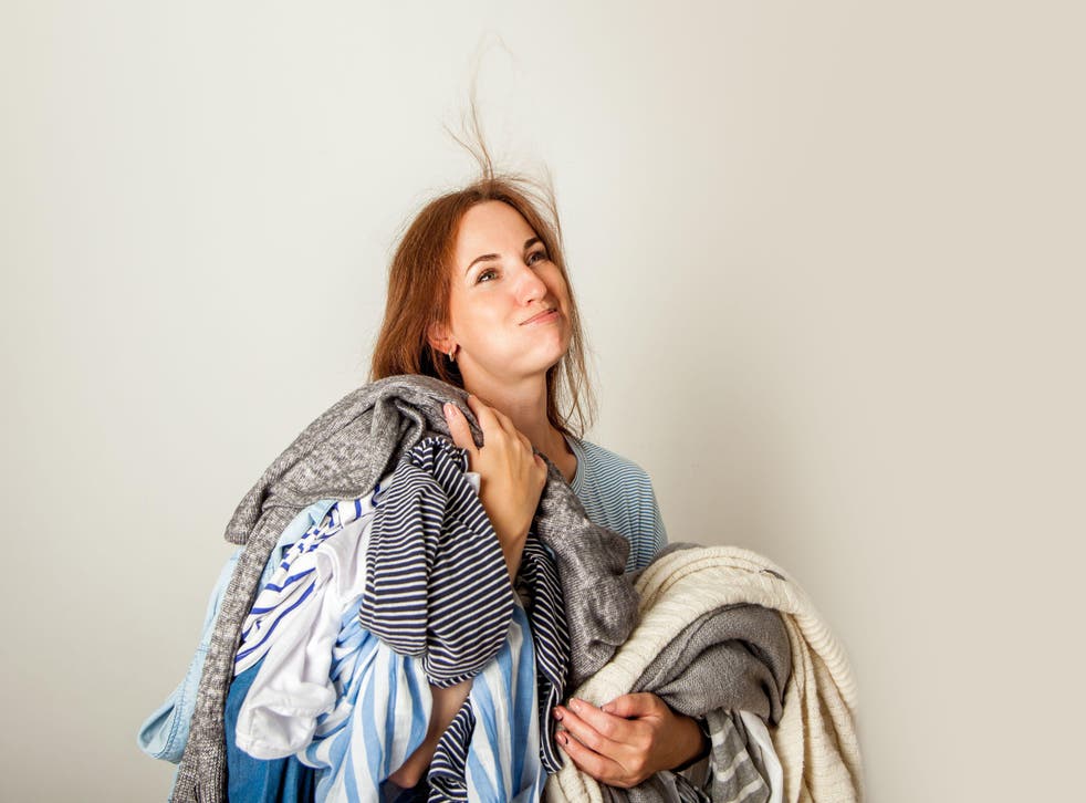 Woman holding a messy pile of clothes