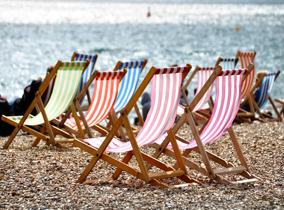 Deckchairs on Brighton beach in summer, Sussex, England, UK