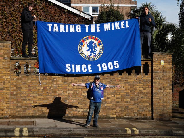 Chelsea fans with a flag outside the stadium