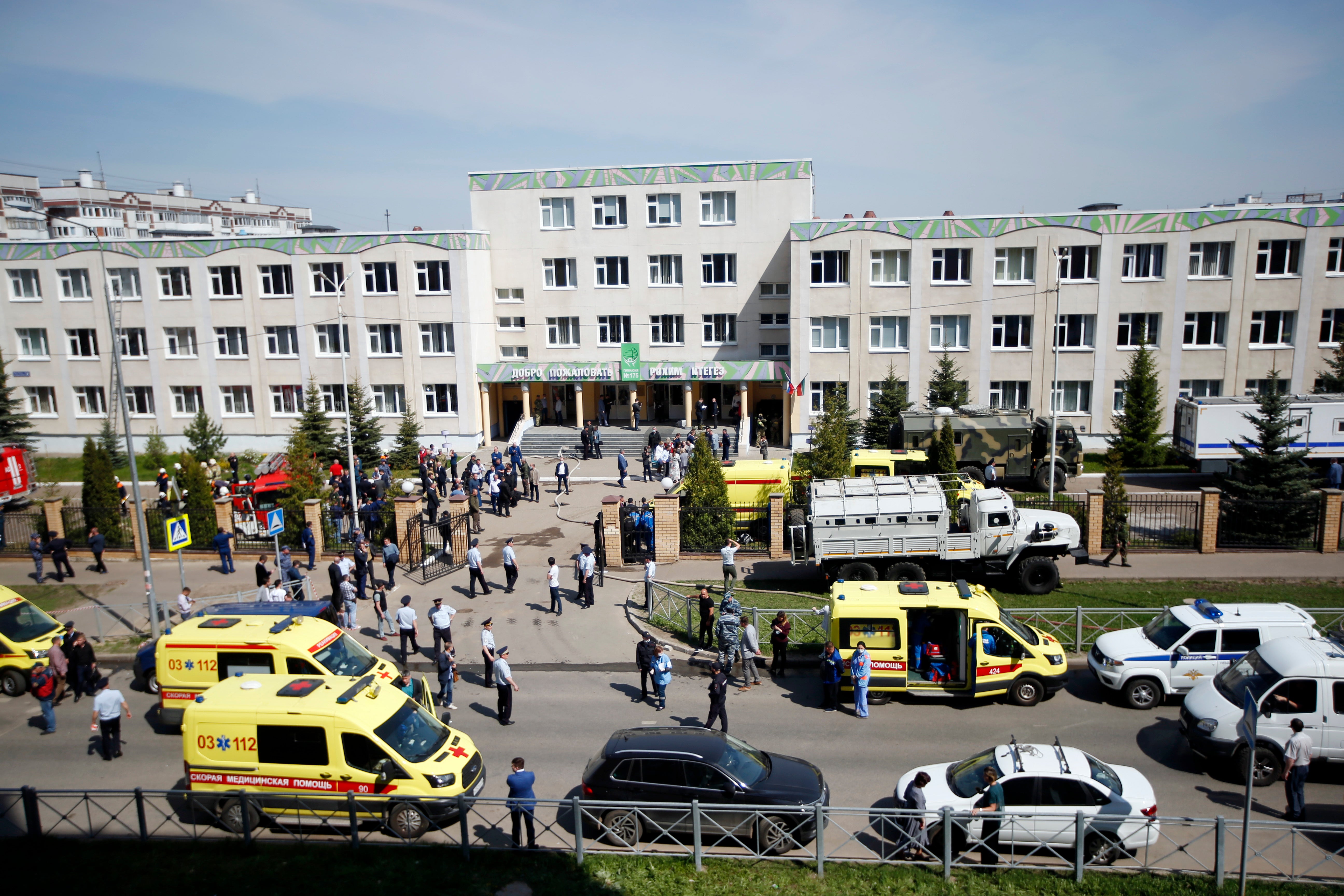 Ambulances and police cars and a truck are parked at a school after a shooting by Ilnaz Galyaviev in Kazan, Russia, in May 2021