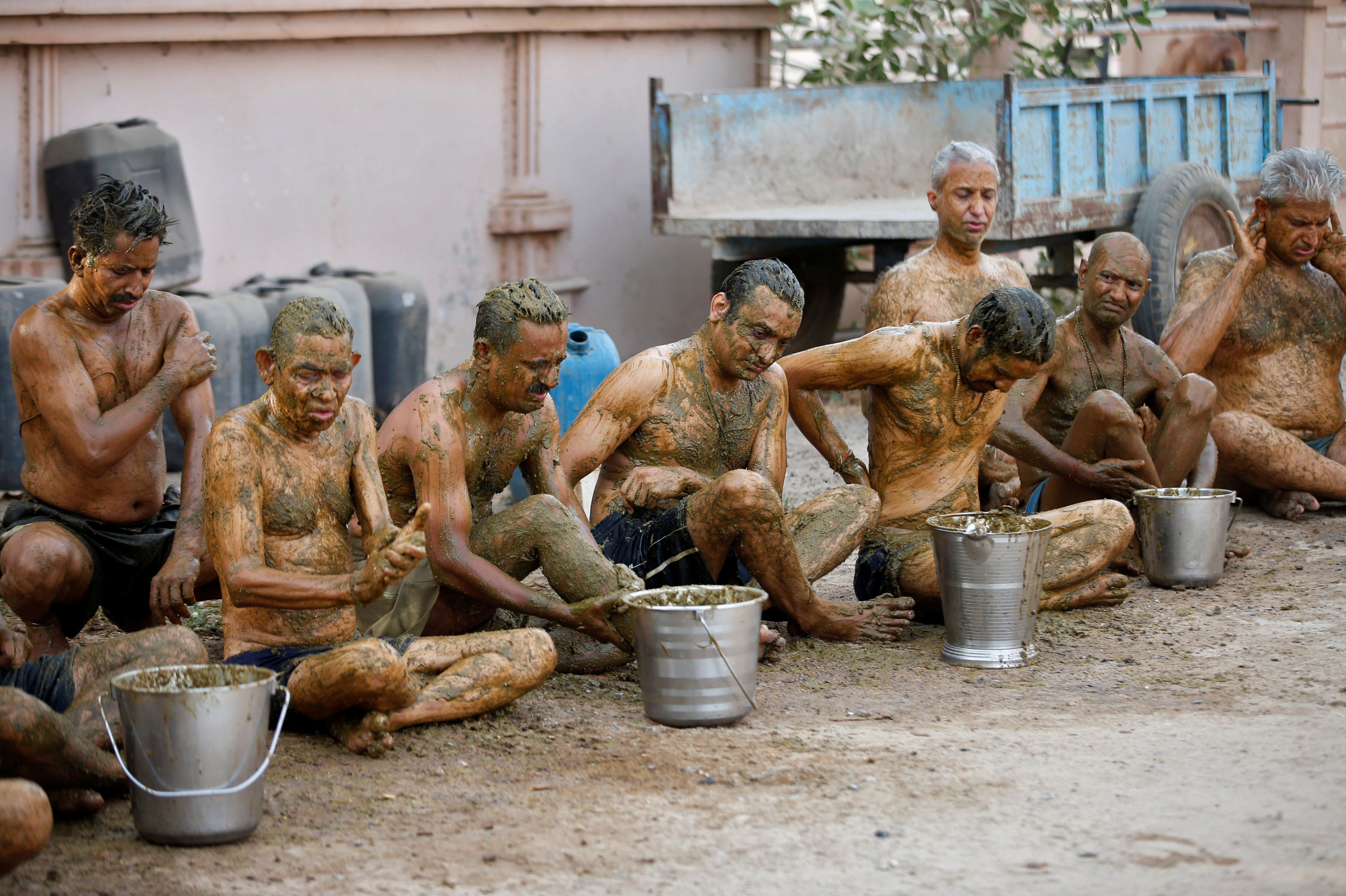 People applying cow dung