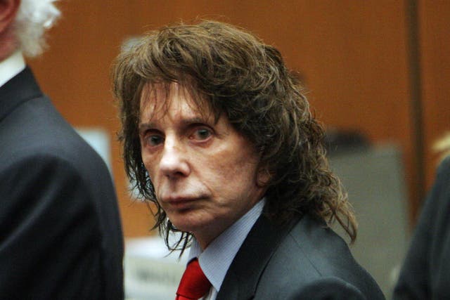 Phil Spector flanked by lawyers at his murder trial in 2009