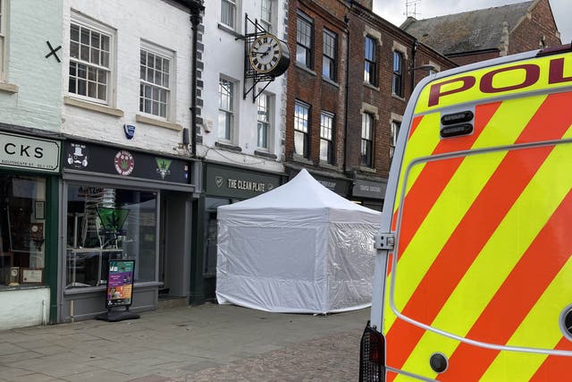 <p>A police tent outside The Clean Plate cafe in Southgate Street, Gloucester</p>