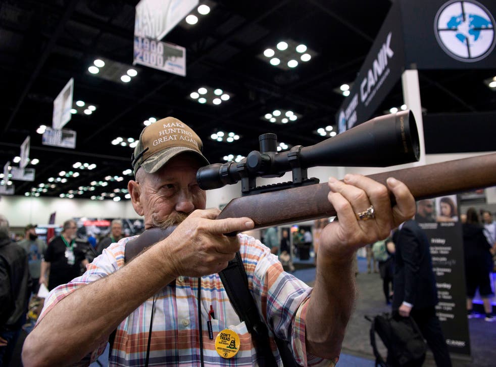 <p>Mark McKenzie of Tulsa, Oklahoma, looks through the scope of a deactivated rifle at the 2019 National Rifle Association (NRA) Annual Meetings and Exhibits in Indianapolis, Indiana, on April 26, 2019. </p>