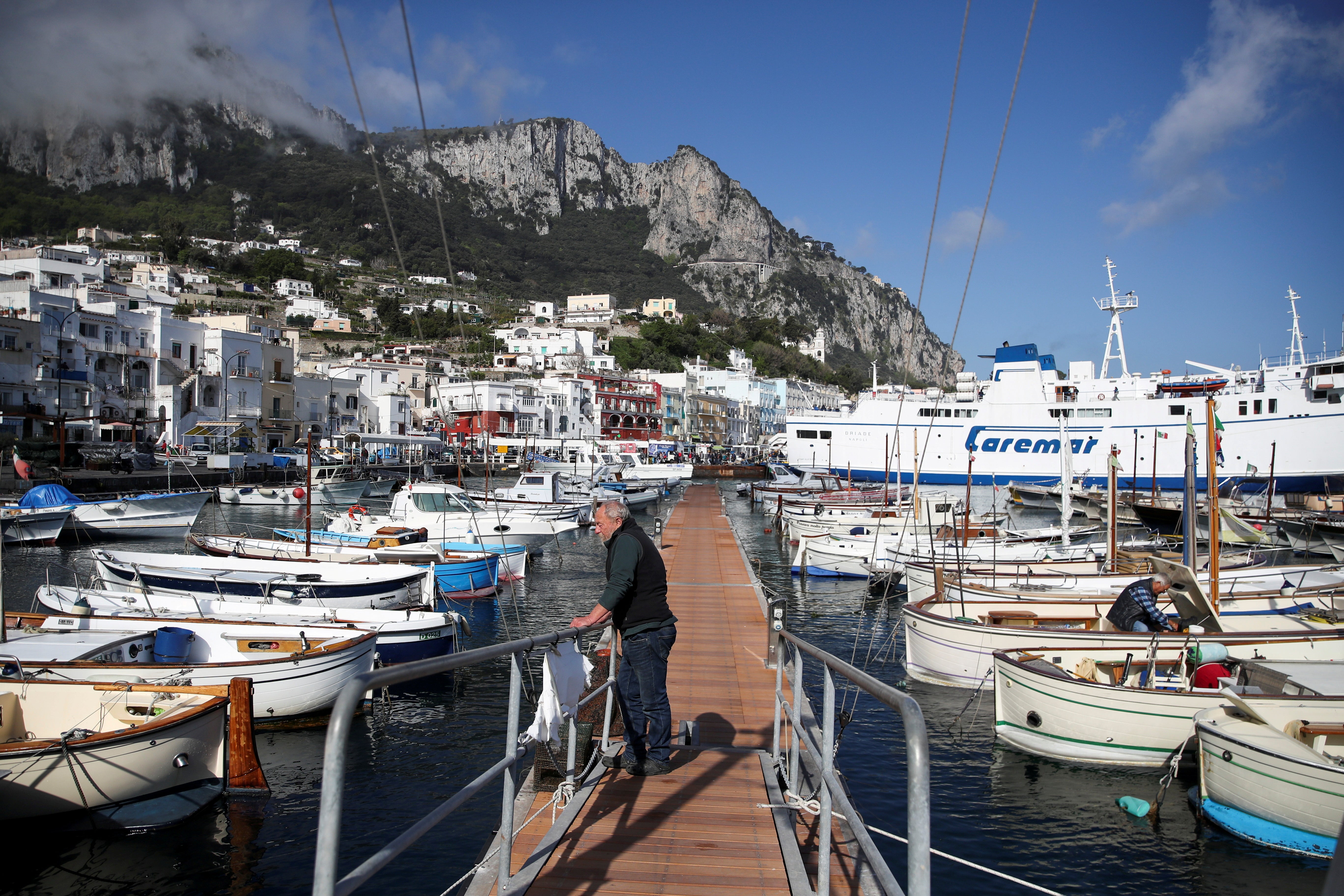 A man looks on in Marina Grande, the main port of the island of Capri, on 28 April, 2021.