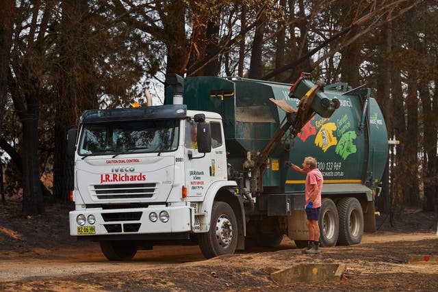 <p>Representative: A garbage truck is pictured as it drives around town picking up residents bins as they are filled with burnt debris on 6 January 2020 in Wingello, Australia</p>