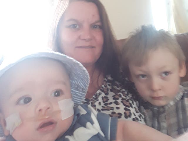 <p>Rebecca Currie and her son Matthew with brother Denzel</p>