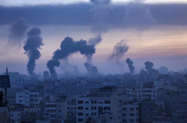 <p>Smoke and flames rise from Gaza City yesterday Wednesday</p>
