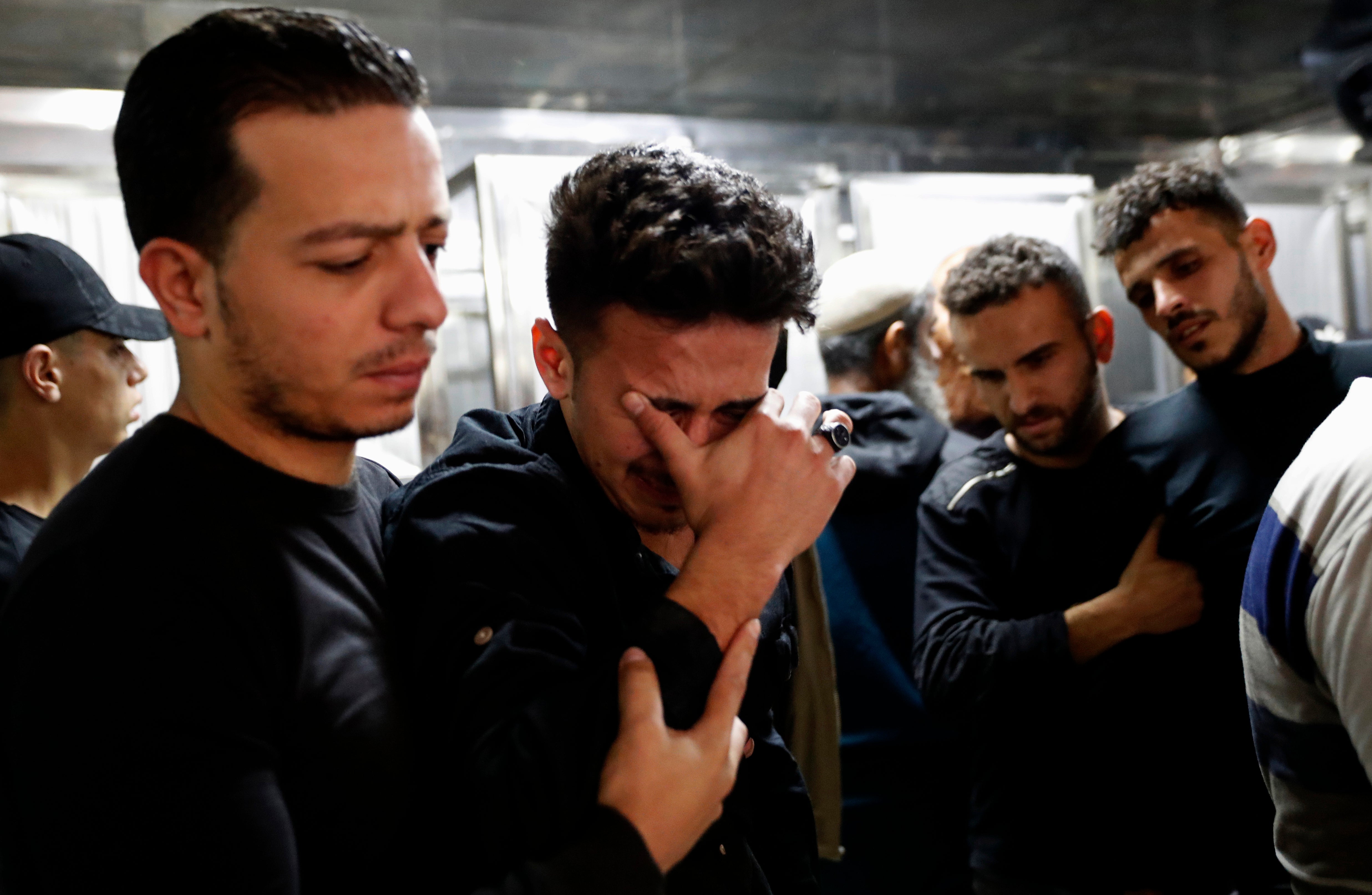 Relatives mourn during the funeral of Reema Telbani and her 5-year-old son Zaid, who were killed in Israeli airstrikes on an apartment building in Gaza