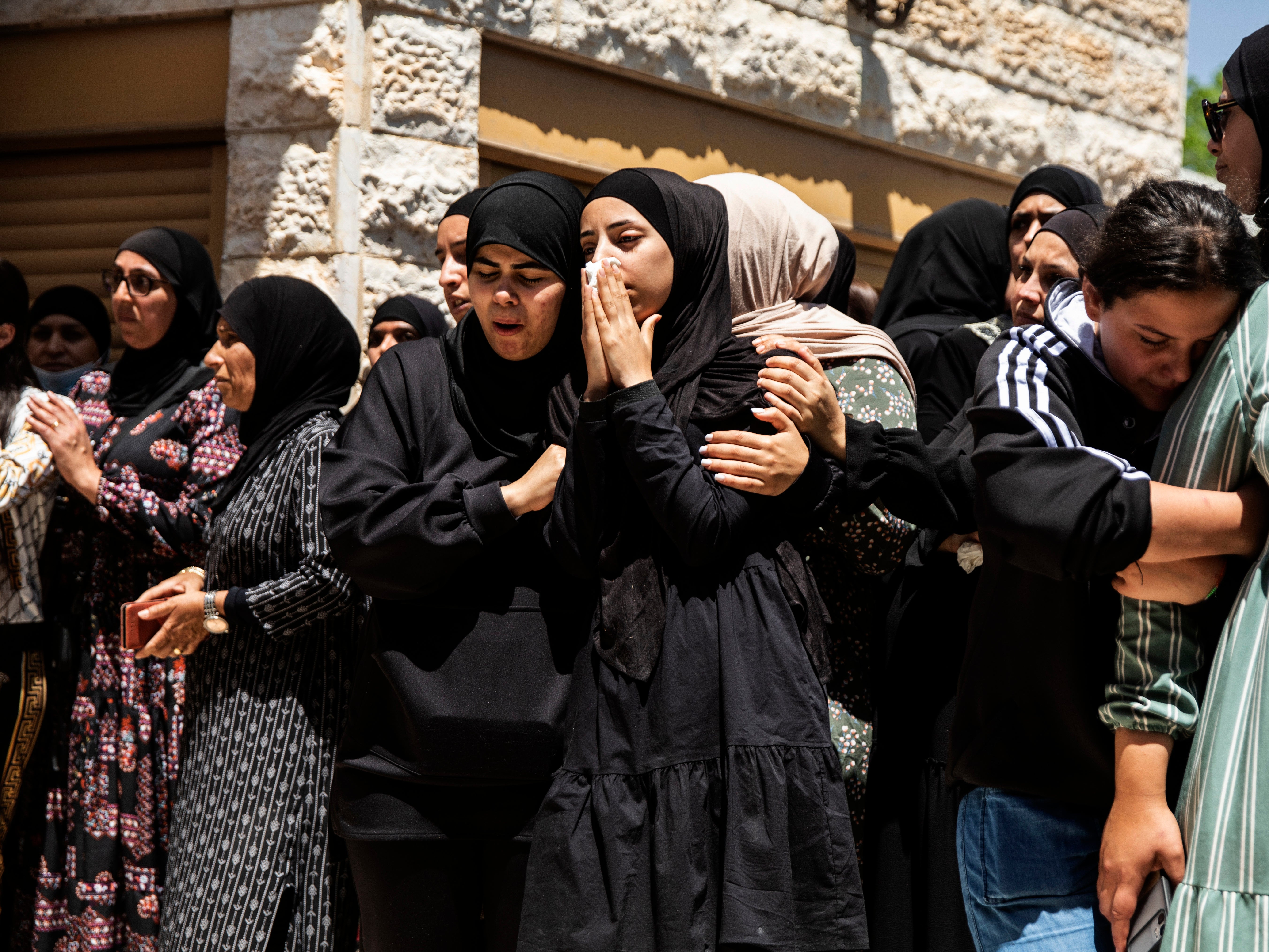 Mourners attend the funeral of Israeli Arab Khalil Awaad and his daughter Nadine, 16, in the village of Dahmash near the Israeli city of Lod
