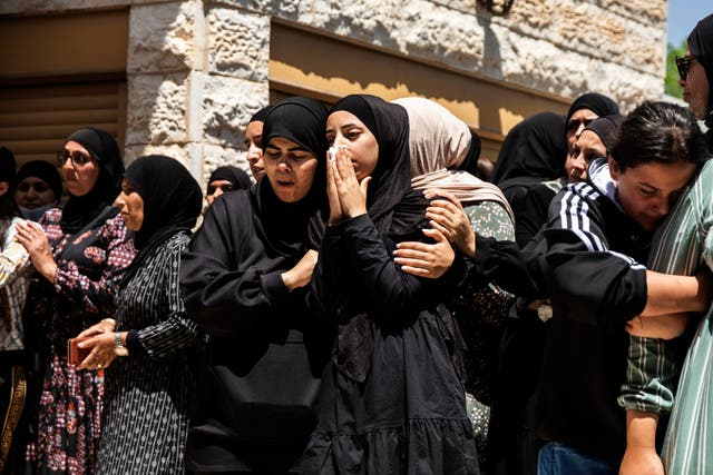 <p>Mourners attend the funeral of Israeli Arab Khalil Awaad and his daughter Nadine, 16, in the village of Dahmash near the Israeli city of Lod</p>